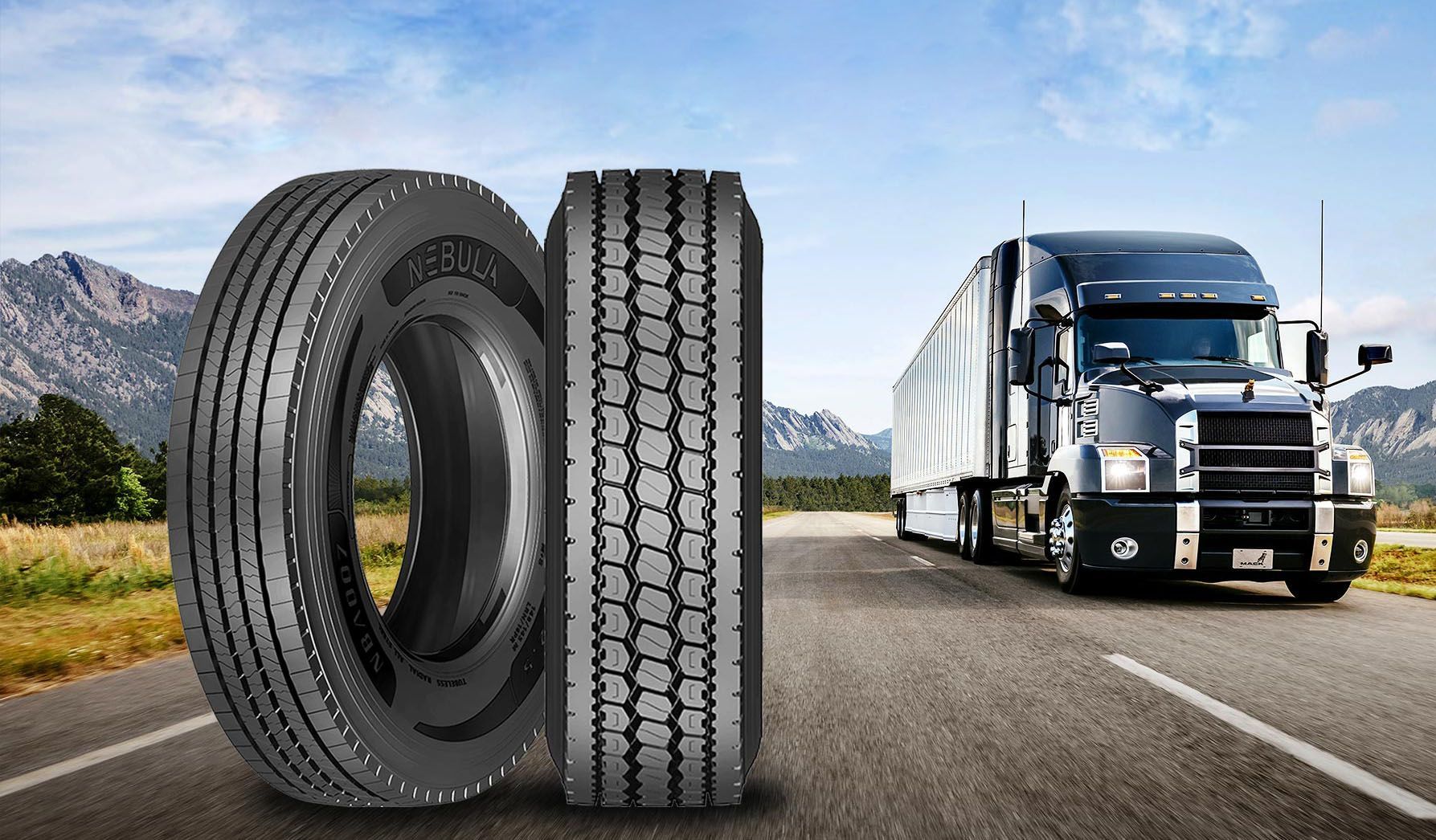 A truck is driving down a road next to two tires.
