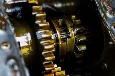 A close up of a gearbox with a lot of gears in it.