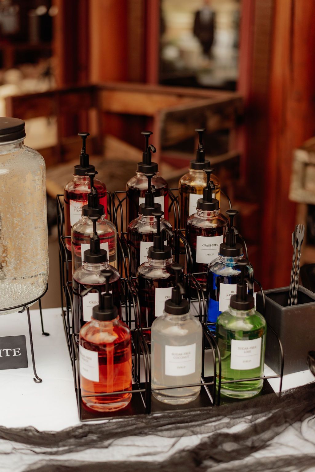 Assorted liquor bottles displayed on a bar counter with warm wood tones