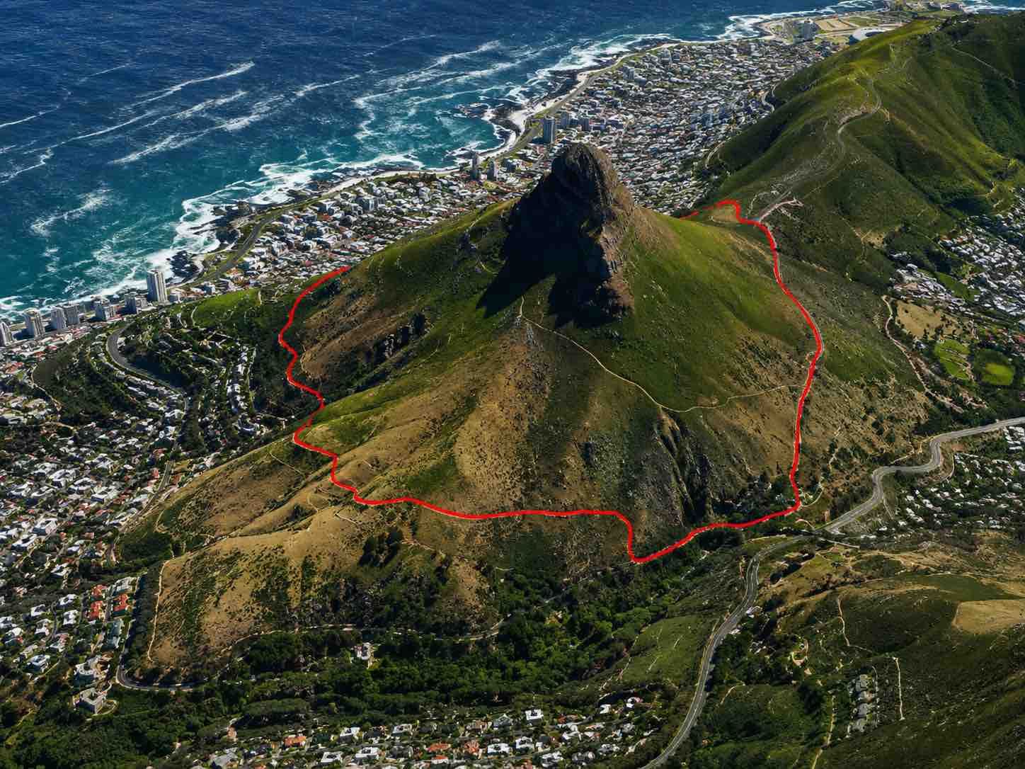 Aerial 3D-style view of the Lion’s Head Contour Path Loop in Cape Town, showing a red hiking route around Lion’s Head with the Atlantic Ocean, Sea Point, Clifton, and surrounding mountain slopes in the background.
