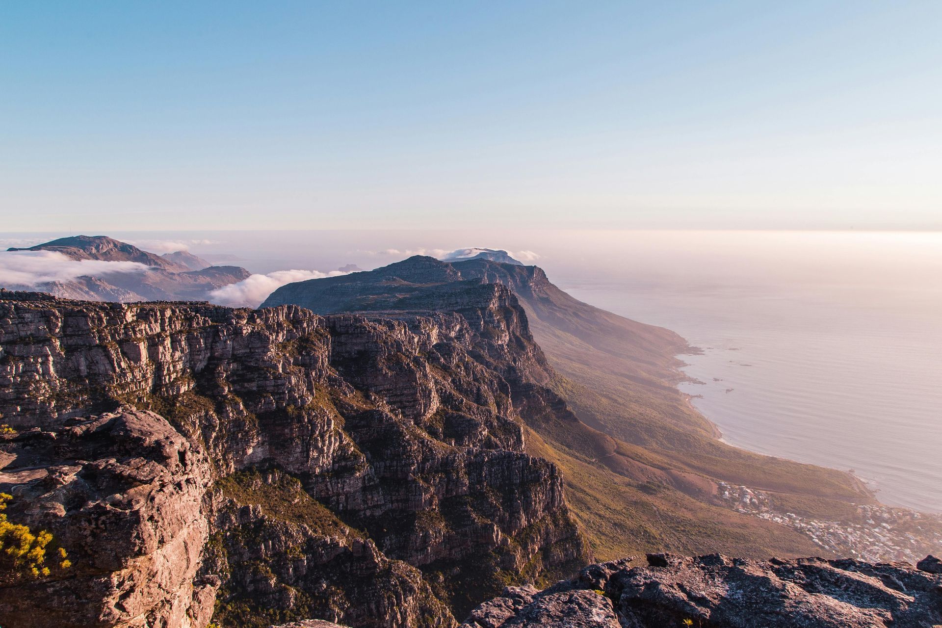 A view of a mountain range with a body of water in the background.