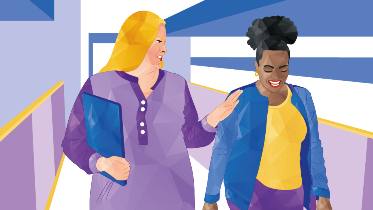 Woman in purple touches shoulder of woman in blue, both smiling, walking in a building.