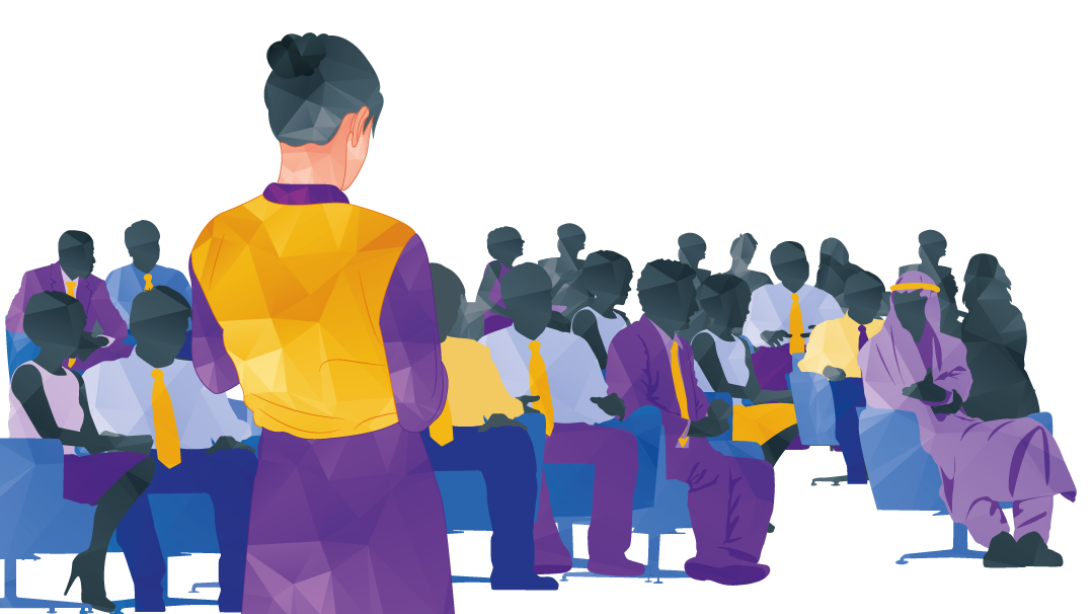 Woman in yellow vest addresses a seated group; business meeting.
