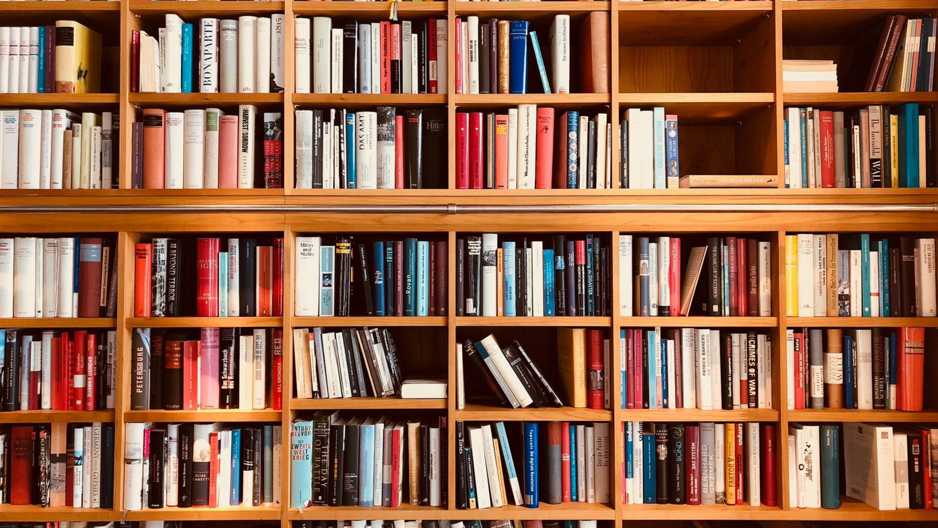 Bookshelves filled with various books of different sizes and colors.