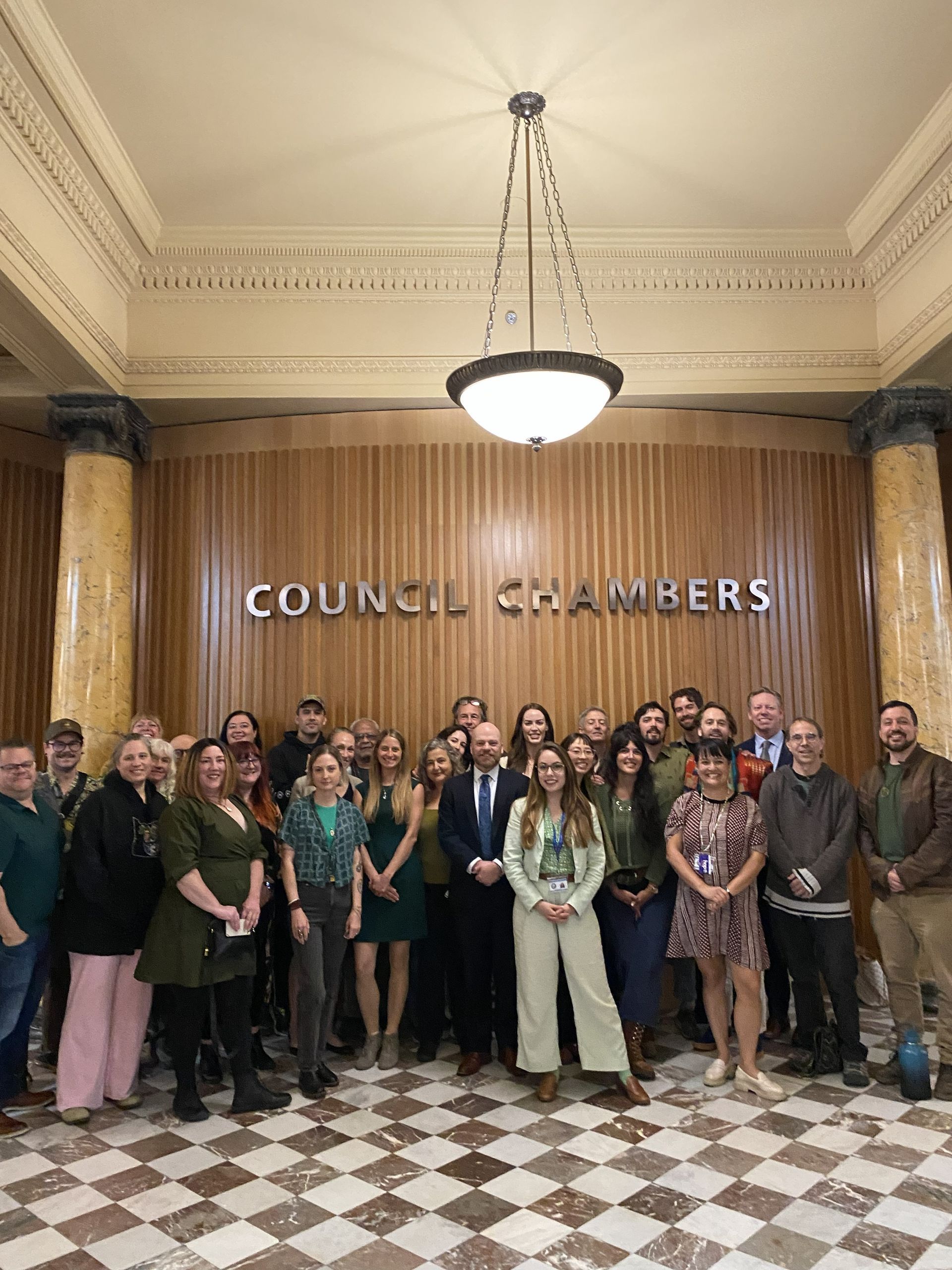 Stakeholders, community members, and the Act sponsors pose for a photo after first reading on September 23, 2026