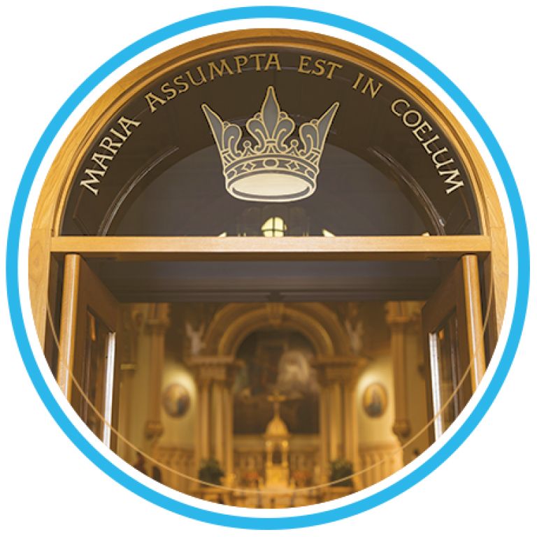 Church entrance with a crown emblem and Latin inscription, seen through a circular frame