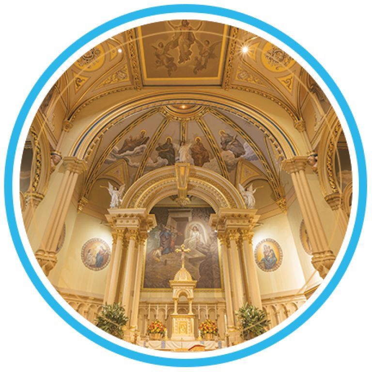 Ornate church altar with gold arches, frescoed ceiling, and white columns in a bright sanctuary