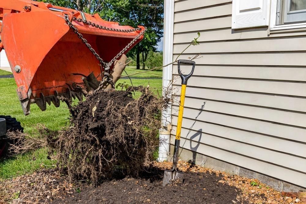 a shovel is sitting next to a pile of dirt next to a house .