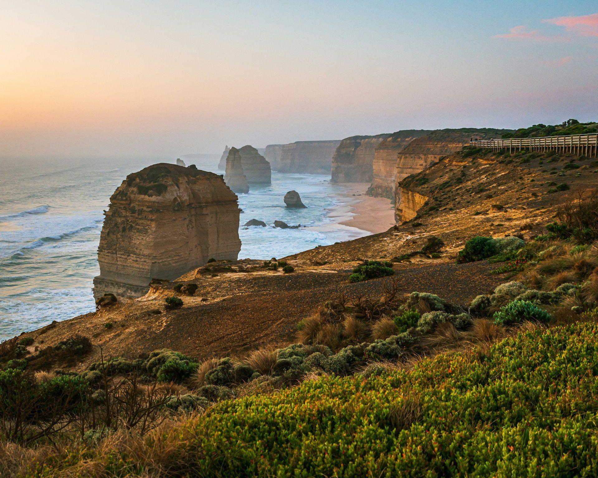 A view of a cliff overlooking the ocean at sunset. A view of a cliff overlooking the ocean at sunset.