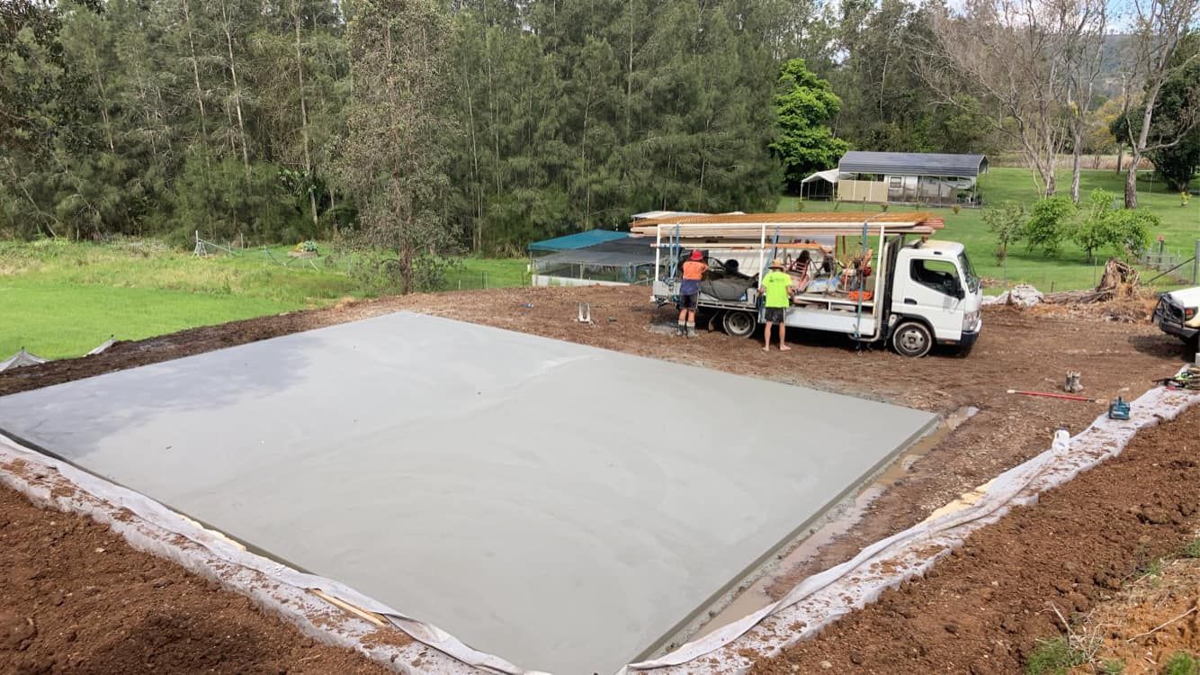 A Truck is Parked on Top of a Concrete Slab in a Field — Crete to Coast Concreting in Jimboomba, QLD