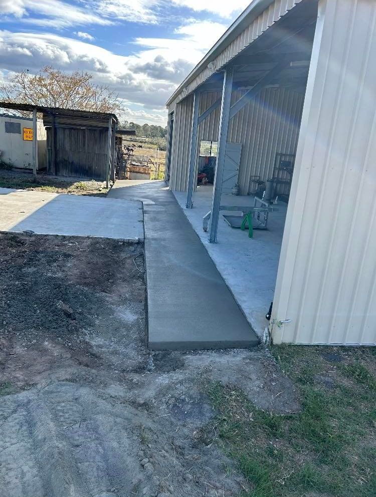 A Concrete Walkway is Being Built in Front of a Shed — Crete to Coast Concreting in Tamborine, QLD