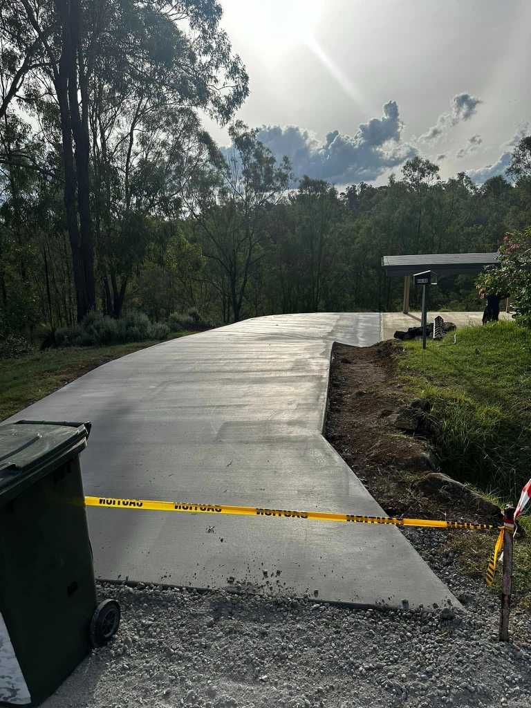 A Concrete Driveway is Being Built Next to a Trash Can — Crete to Coast Concreting in Canungra, QLD