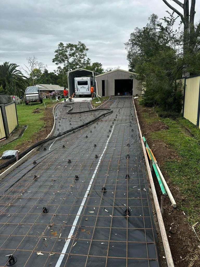 A Concrete Driveway is Being Built in Front of a House — Crete to Coast Concreting in Tamborine, QLD
