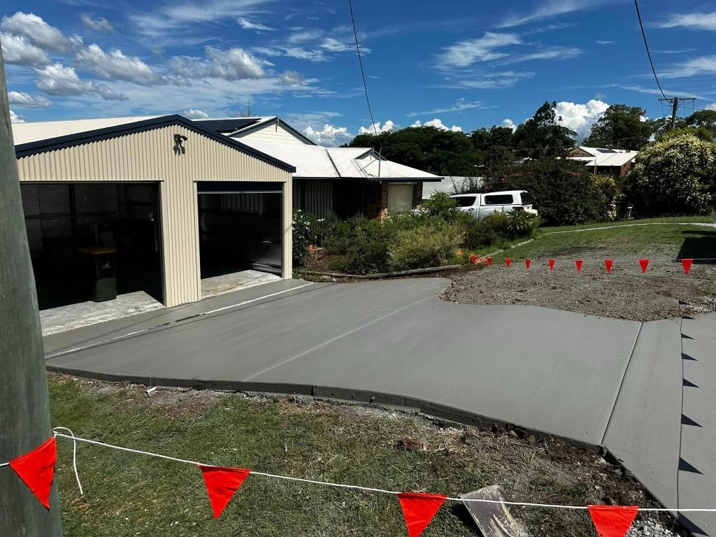 A Concrete Driveway is Being Built in Front of a House — Crete to Coast Concreting in Tamborine, QLD