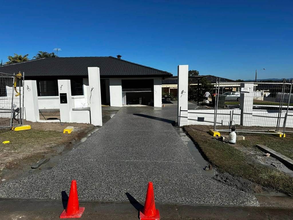 A House is Being Built With a Gravel Driveway — Crete to Coast Concreting in Jimboomba, QLD