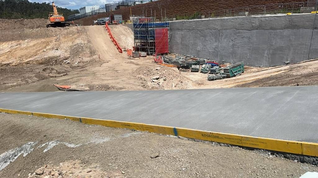A Construction Site With a Road and a Wall in the Background — Crete to Coast Concreting in Browns Plains, QLD