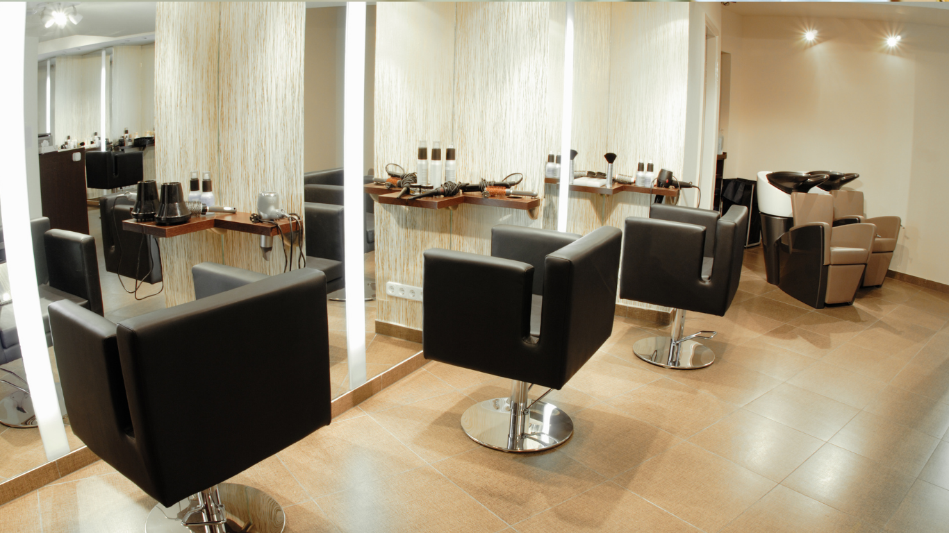 Modern hair salon with styling chairs, mirrors, and wooden flooring