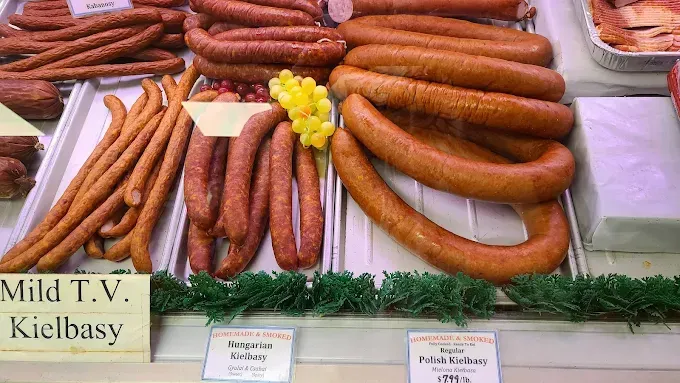 Display case of various sausages: kielbasa, links, and long sticks.