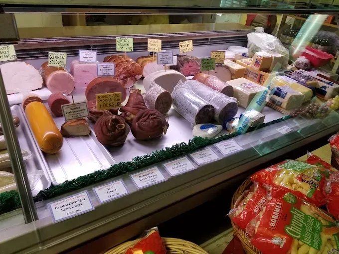 Deli display case with various meats and cheeses.
