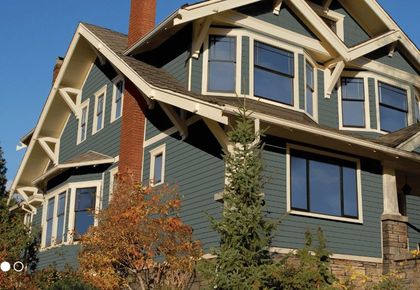 A large house with a lot of windows and a chimney