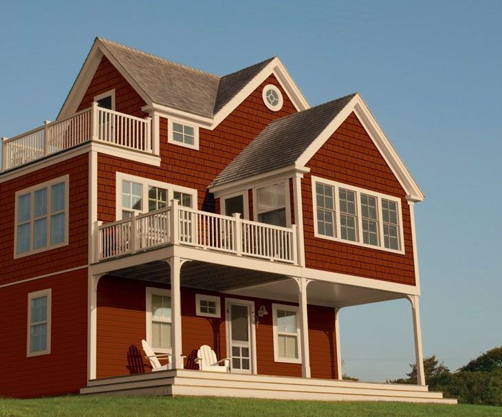 A large red house with white trim and a porch