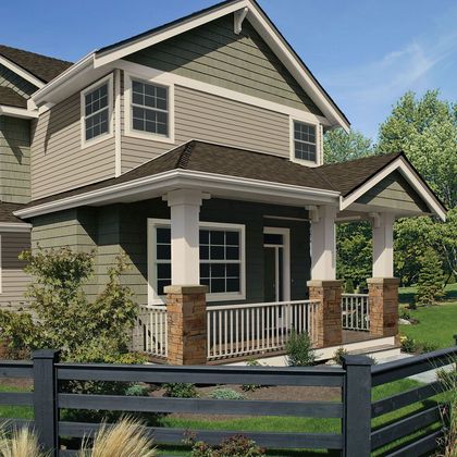 A house with a black fence in front of it