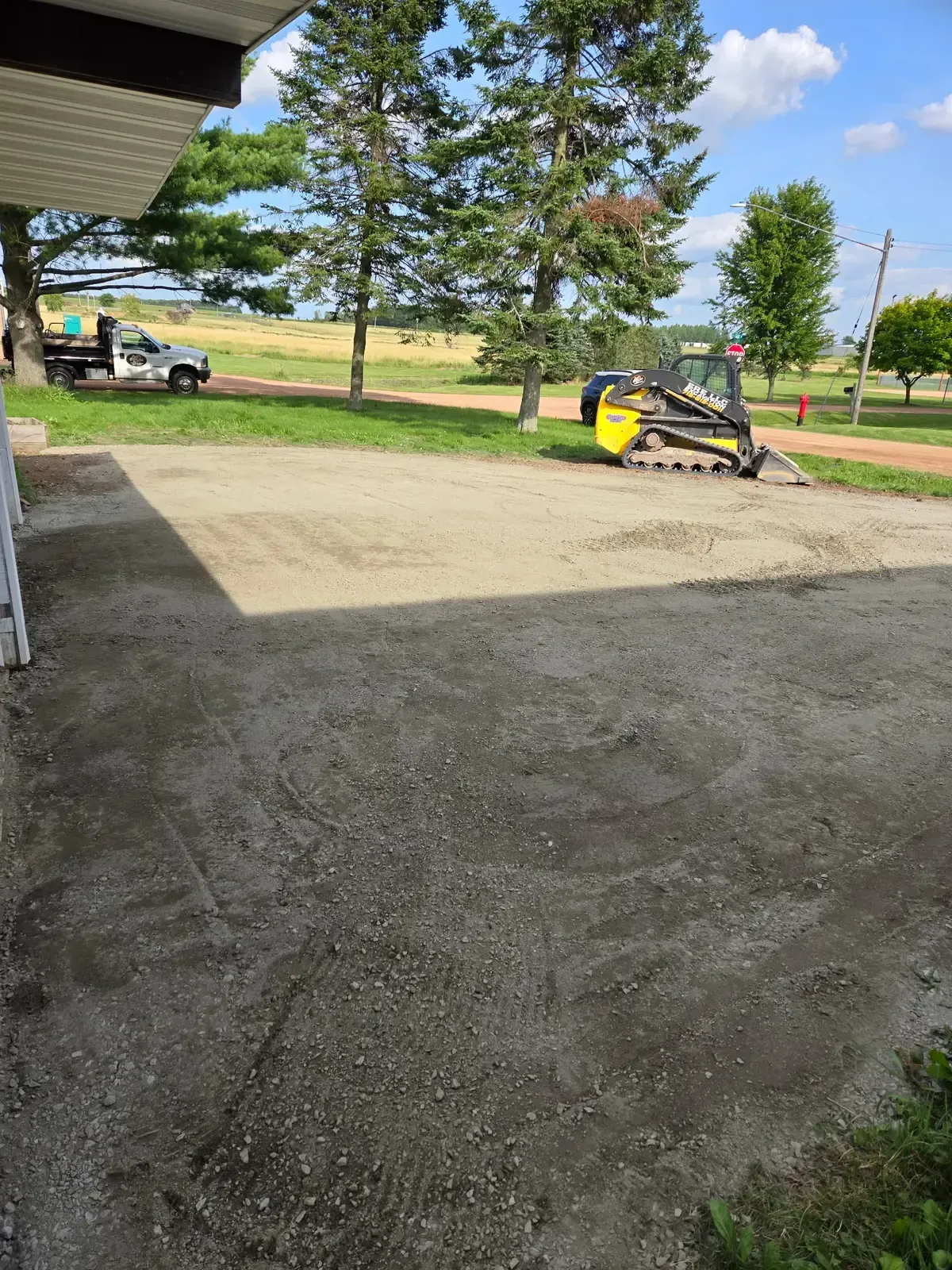 Finished gravel driveway rebuild with ERE Excavation track loader and dump truck in Colby, WI
