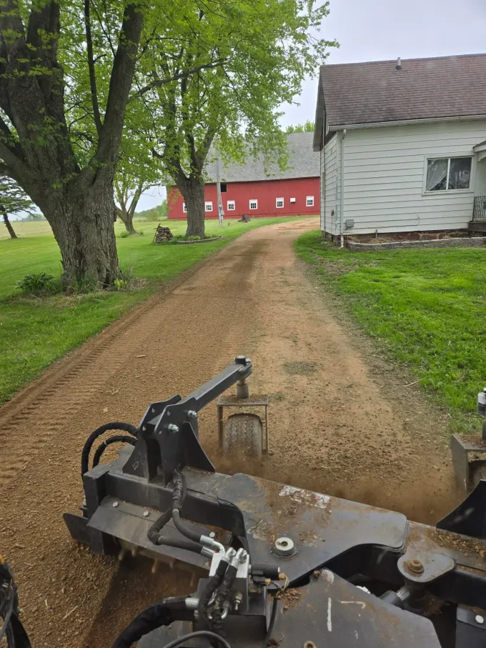 Compacting a new gravel driveway near a farm outbuilding – ERE Excavation, Central Wisconsin