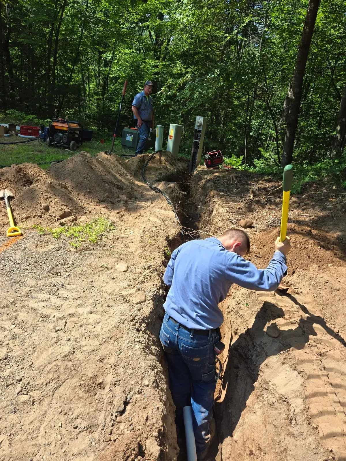 Crew trenching and burying an electrical line near utility meters – ERE Excavation, Central Wisconsin
