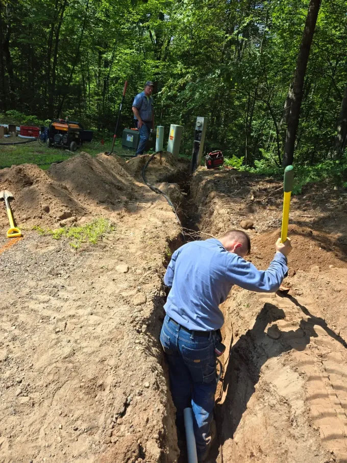 Crew trenching and burying an electrical line near utility meters – ERE Excavation, Central Wisconsin