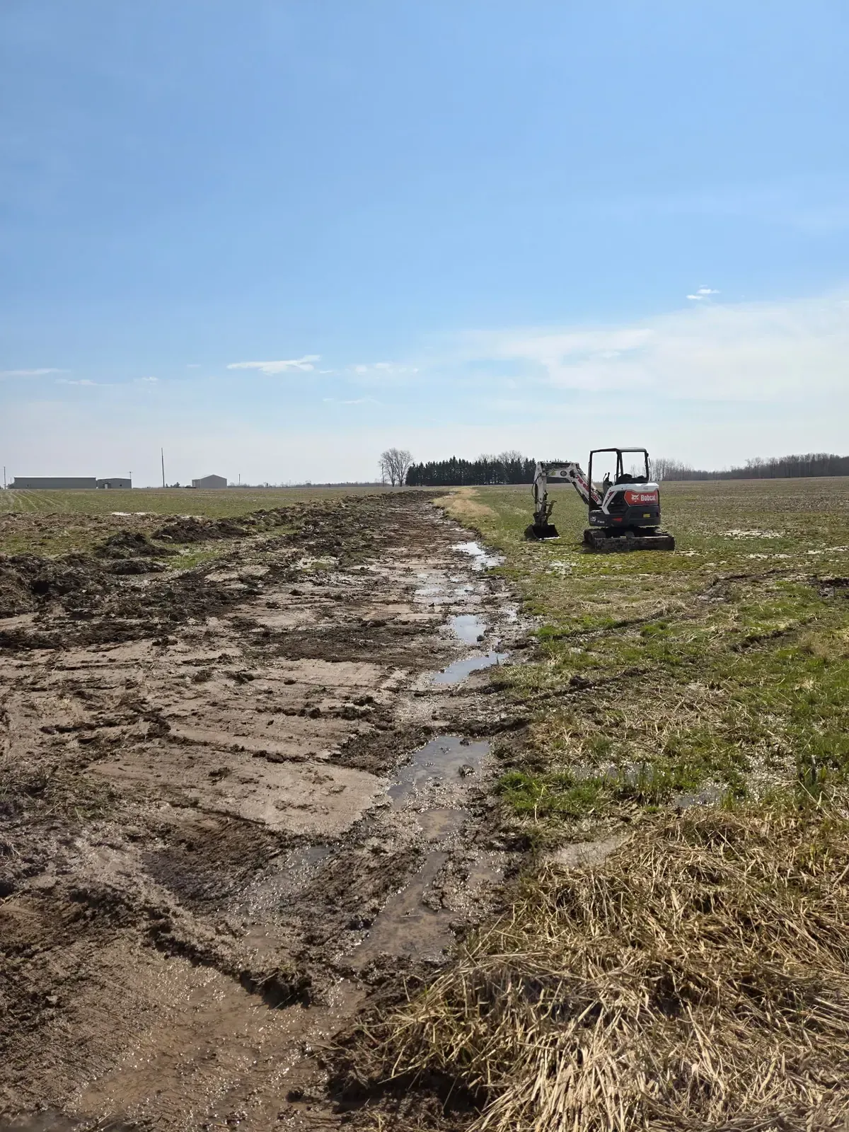 Newly dug agricultural waterway carrying runoff across a farm field in Colby, WI