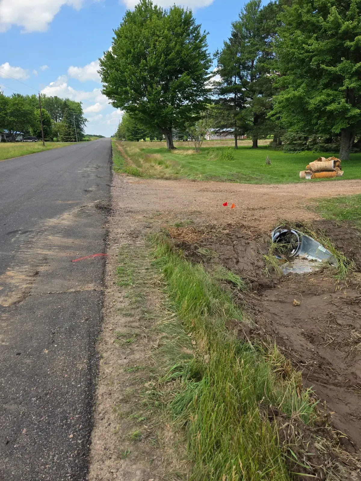 Completed driveway culvert replacement with galvanized flared end along a rural road in Marshfield, WI
