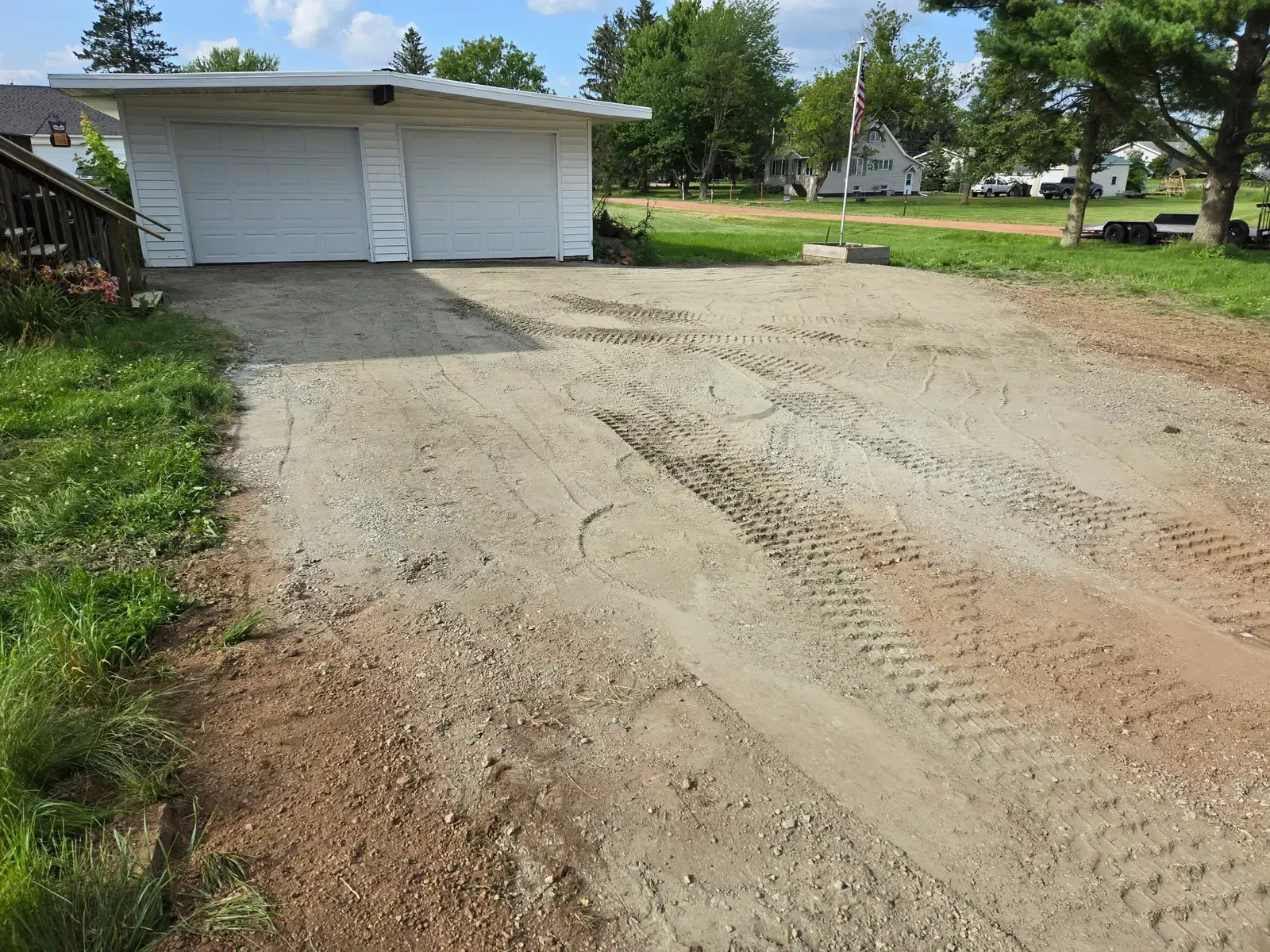 New compacted gravel base for a rebuilt residential driveway in Colby, WI.