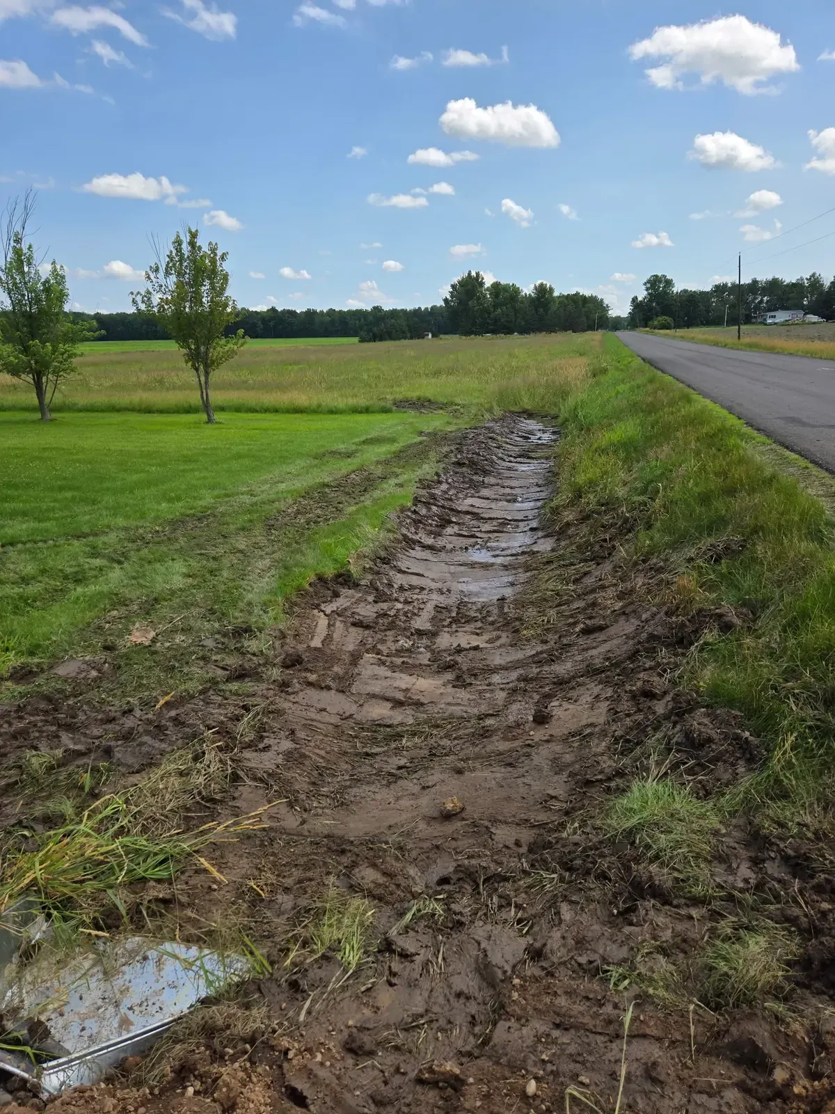 Reshaped roadside ditch leading from a new culvert outlet in Marshfield, WI