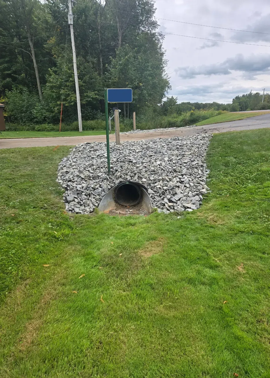 Riprap stone placed around a driveway culvert to prevent erosion along a rural highway in Marshfield, WI