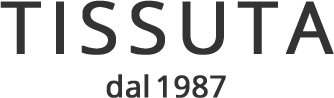 Logo TISSUTA con la scritta “dal 1987” in nero su sfondo bianco.