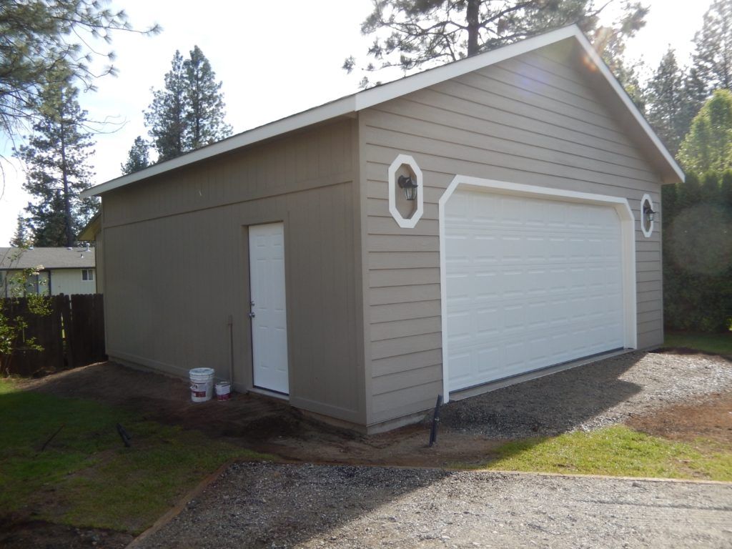 A garage with a white garage door and a white door
