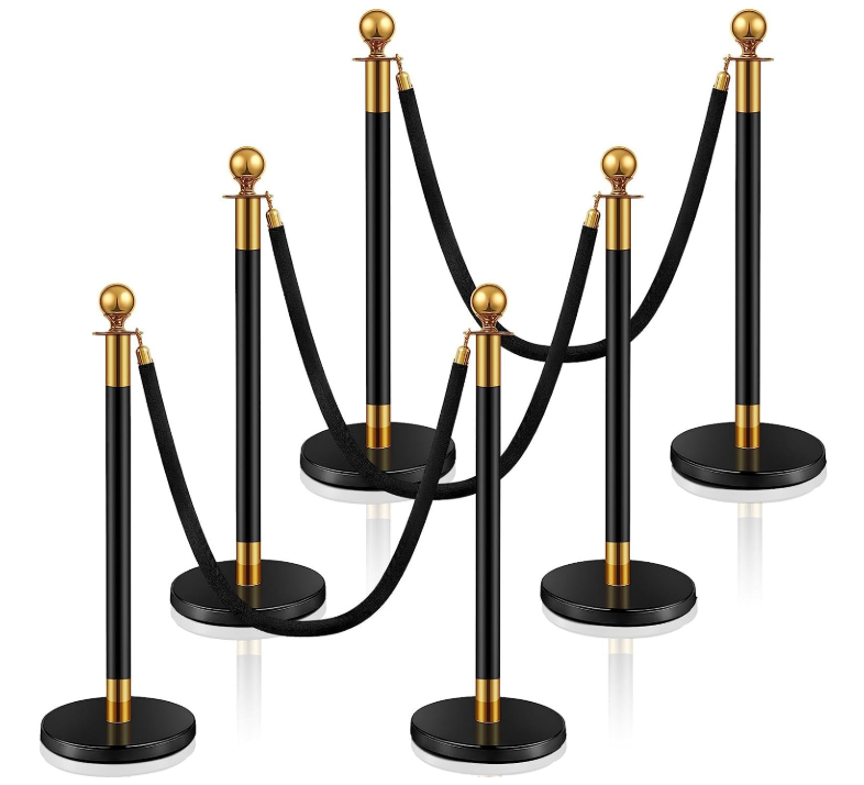 Six black and gold stanchions with black velvet ropes forming a barrier, likely used for crowd control.