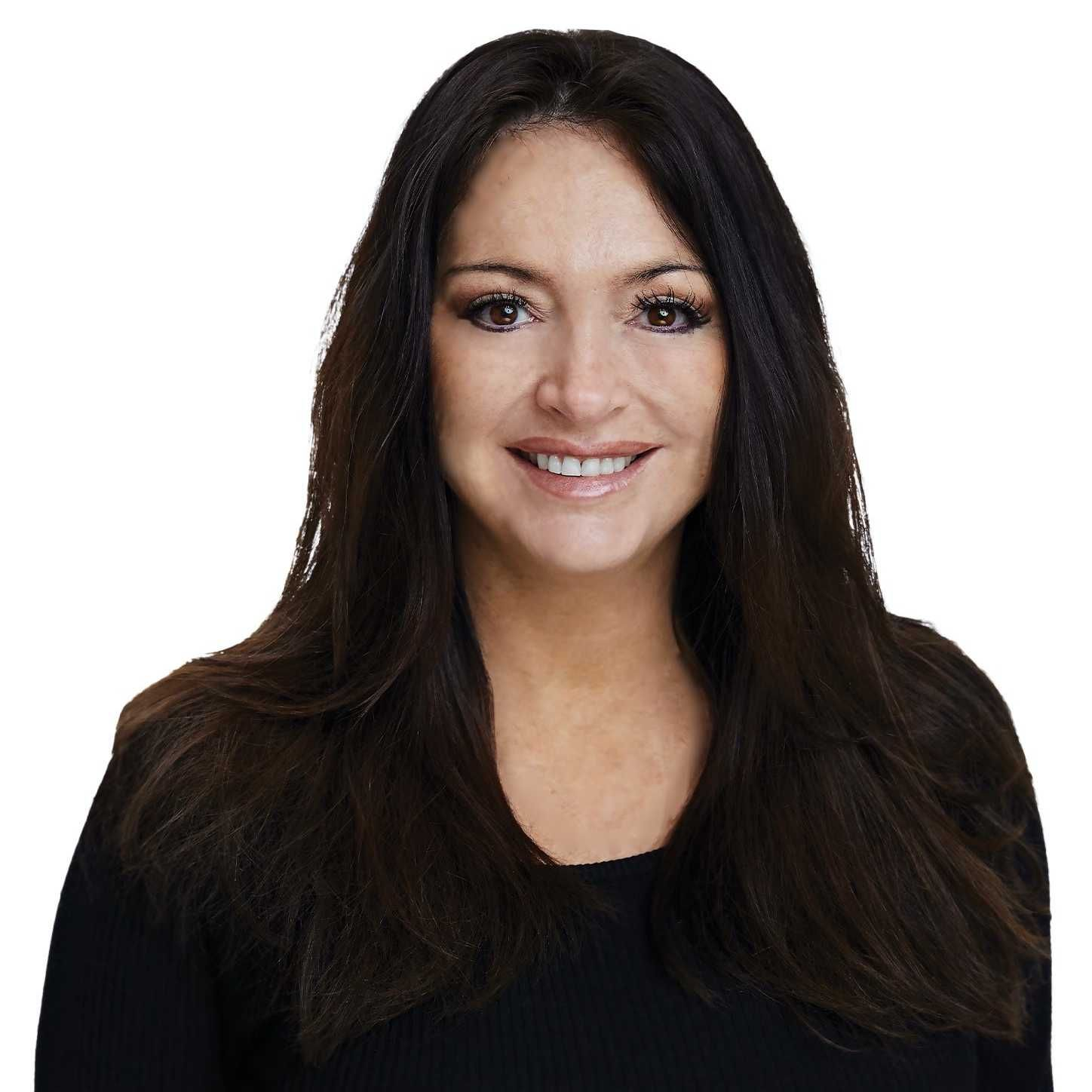 Woman with long dark hair smiles, wearing a black top against a white background.