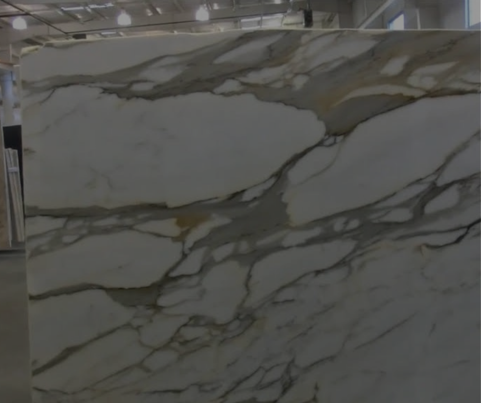 White marble slab with gray and gold veining, indoors.