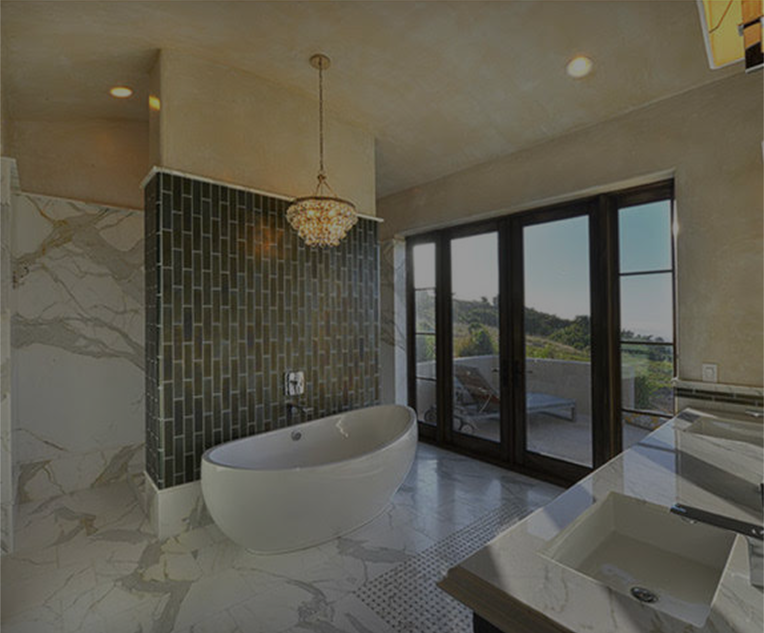 Luxurious bathroom with a free-standing tub, black tile accent wall, marble floors, and large windows.