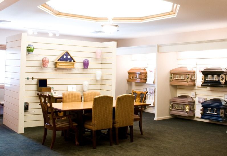 Showroom with dining table and chairs beside shelves of woven baskets and cushions