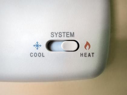 Thermostat with a slider switch labeled