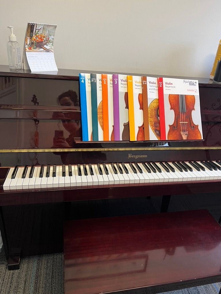 A piano with a bunch of books on it