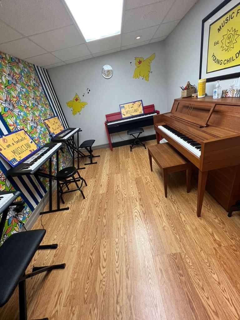 A room with a piano and a bench in it.