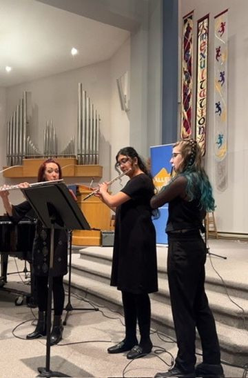 A group of women are playing flutes in a church