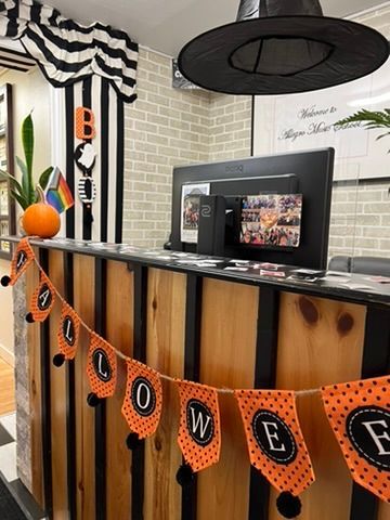 A wooden counter with a halloween banner hanging from it.
