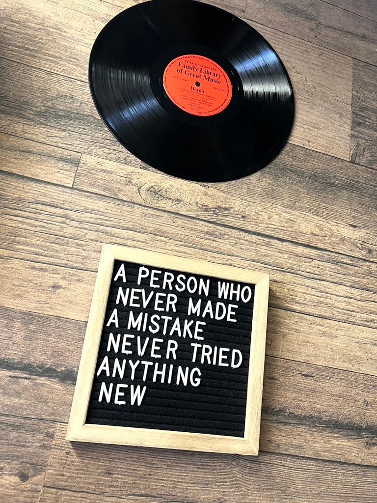 A person who never made a mistake never tried anything new is sitting next to a record.