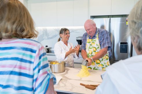Residents cooking together in kitchen