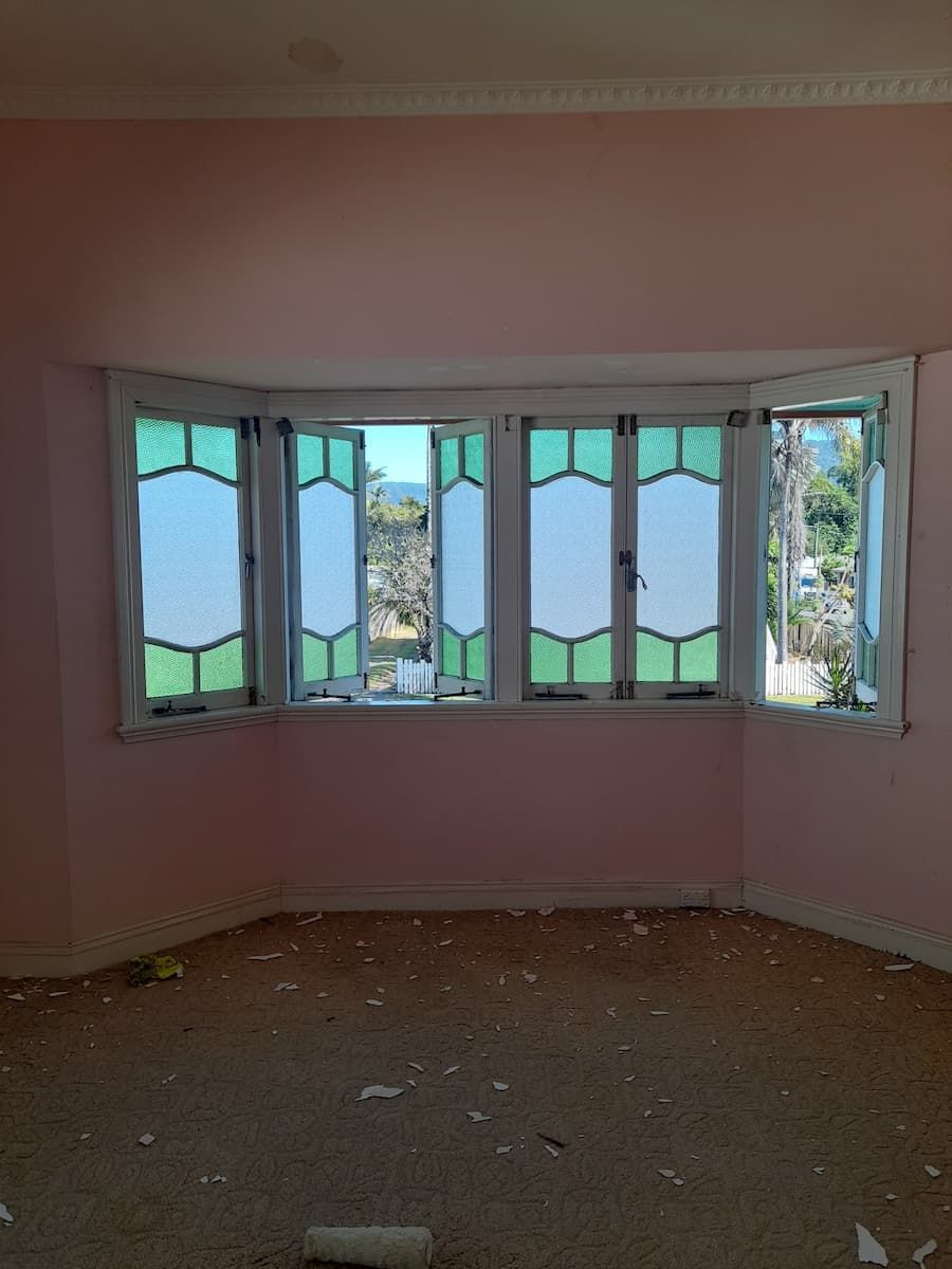 An Empty Room With Stained Glass Windows And Pink Walls — Kiwi Painter In Mooroobool, QLD